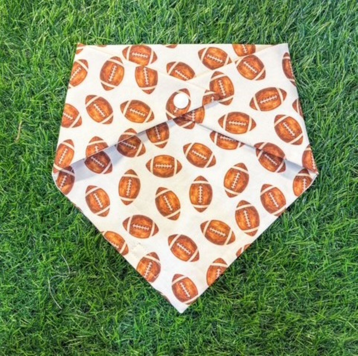 Dog bandana with football pattern on grass