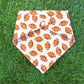 Dog bandana with football pattern on grass
